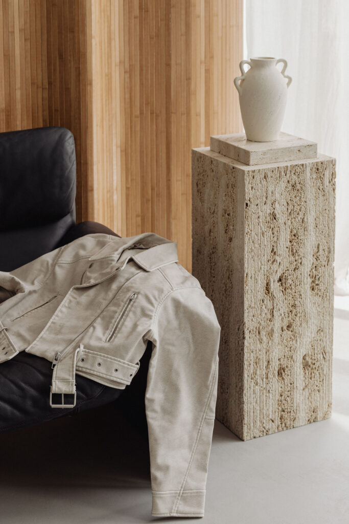 White leather jacket resting on minimalist sofa with natural light – image for mental health journaling blog